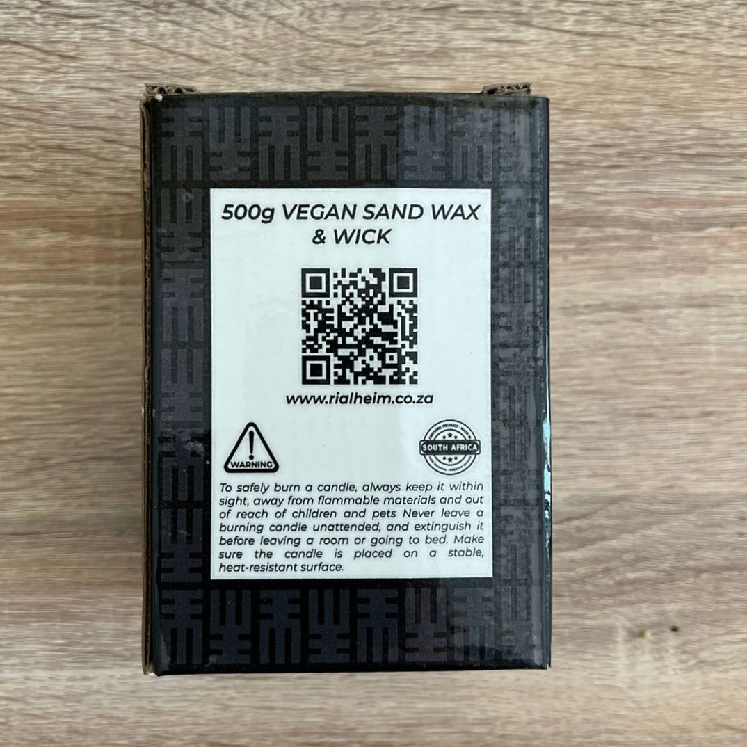 Vegan sand wax and wick packaging with QR code and text on a wooden surface