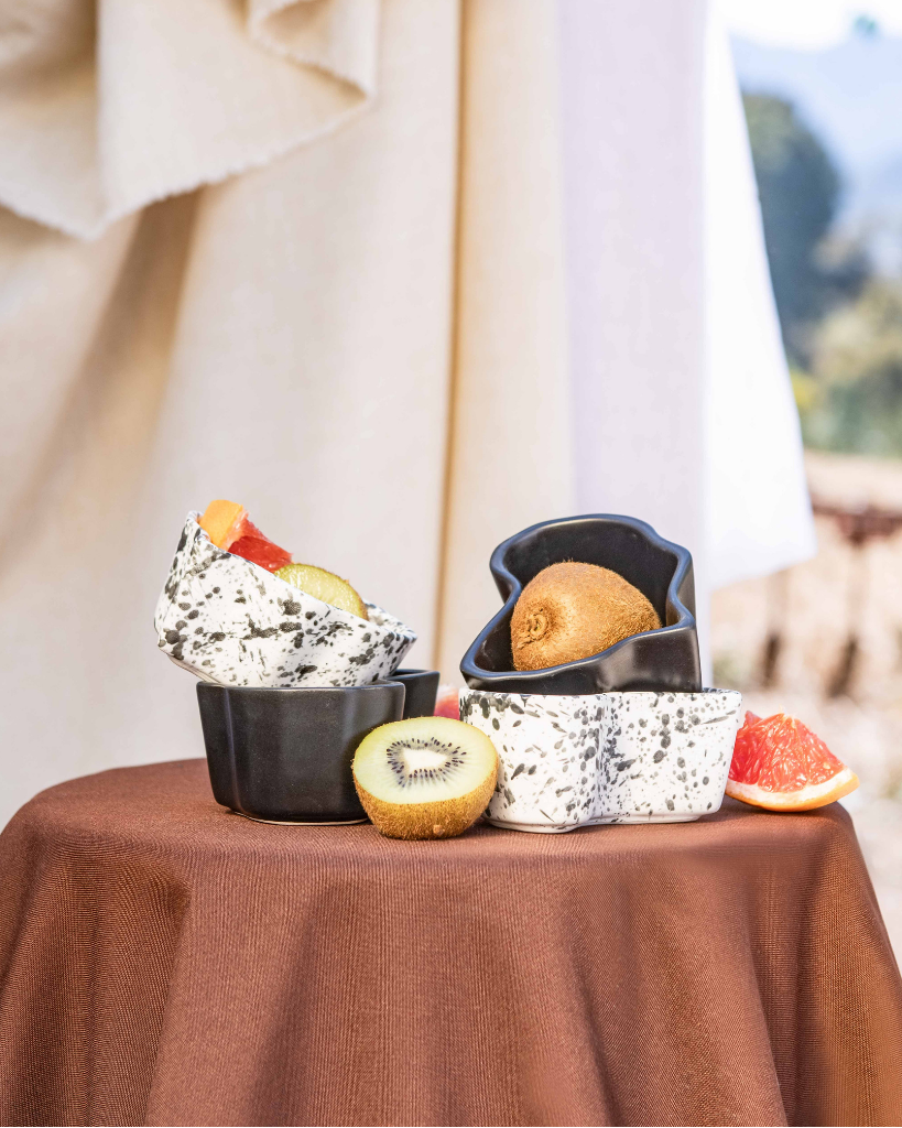 Dessert display in africa shaped ceramic bowls on a table with a scenic background