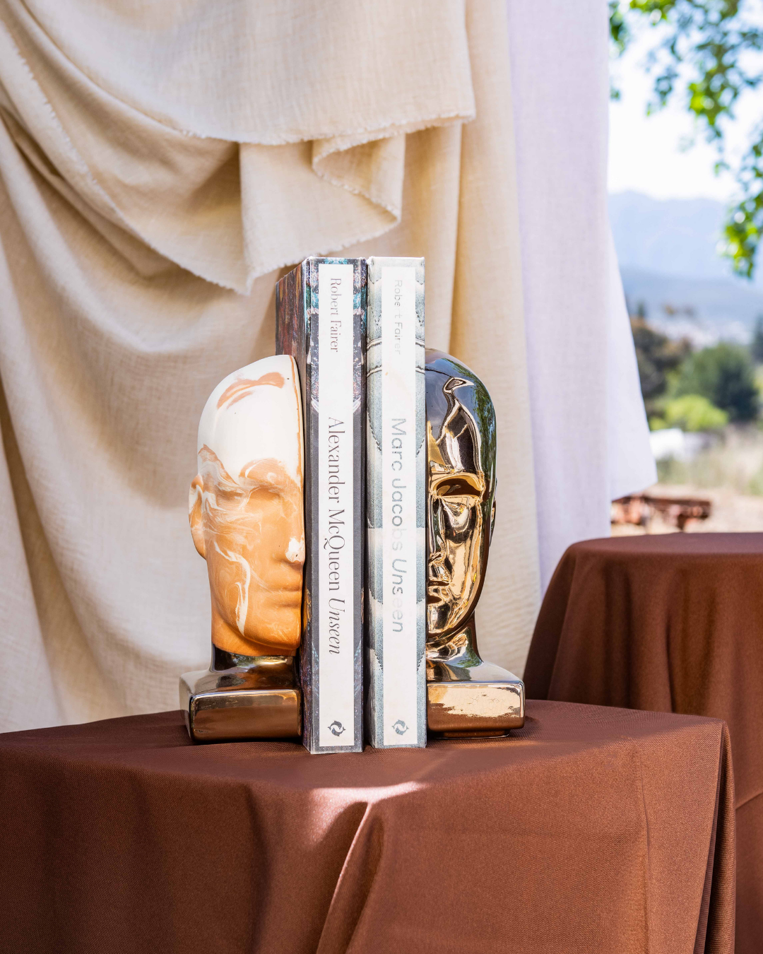 Decorative bookends on a table with a scenic background