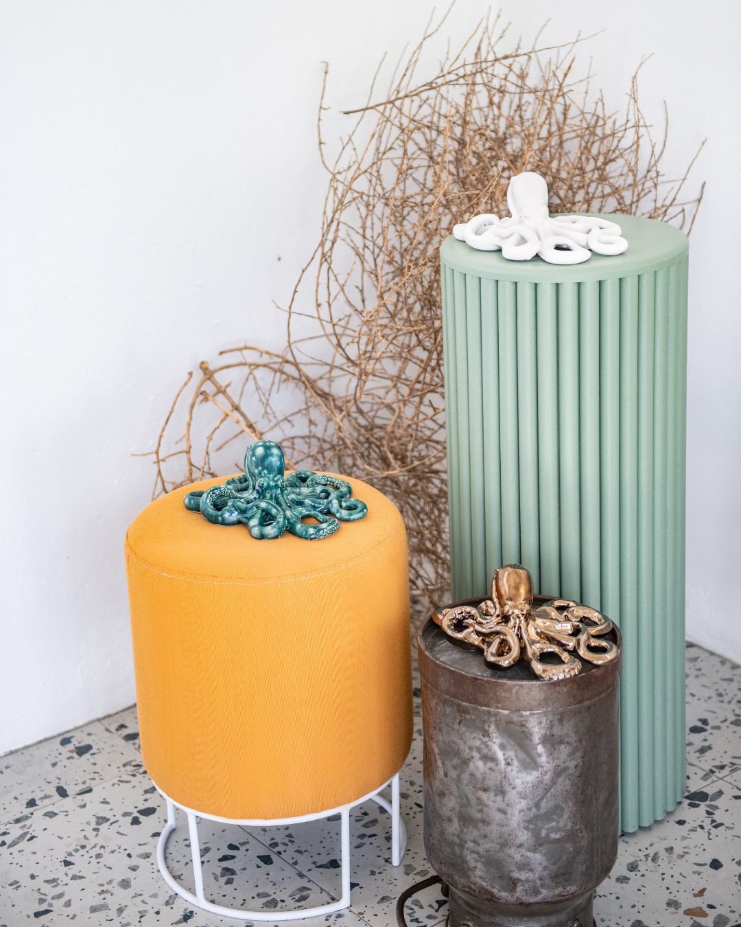 Three decorative octopuses with unique designs on a textured surface.