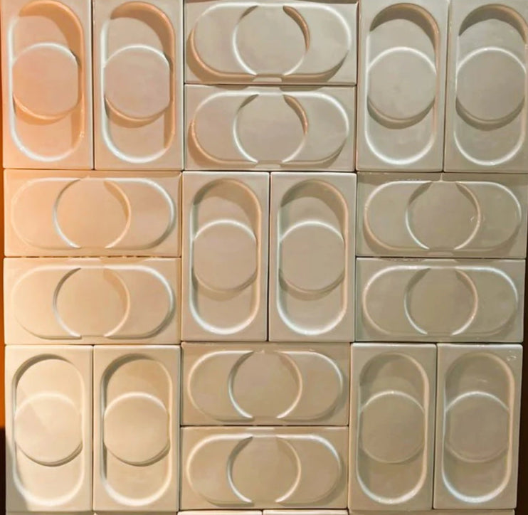 Capsule tile from rialheim in gloss white tiles on a panel to show the patern the tile makes