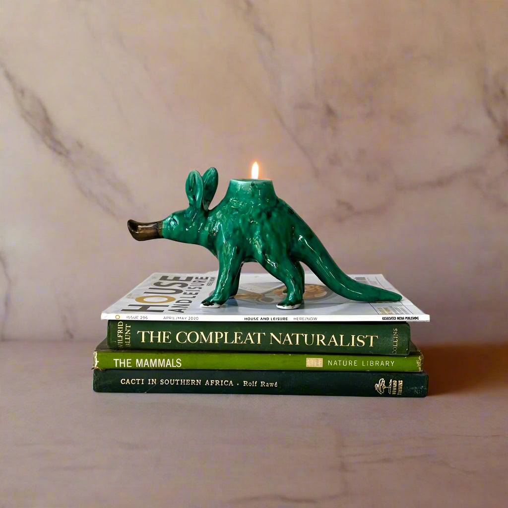 rialheim Candle Holder in emerald green ceramics with black spots on a books