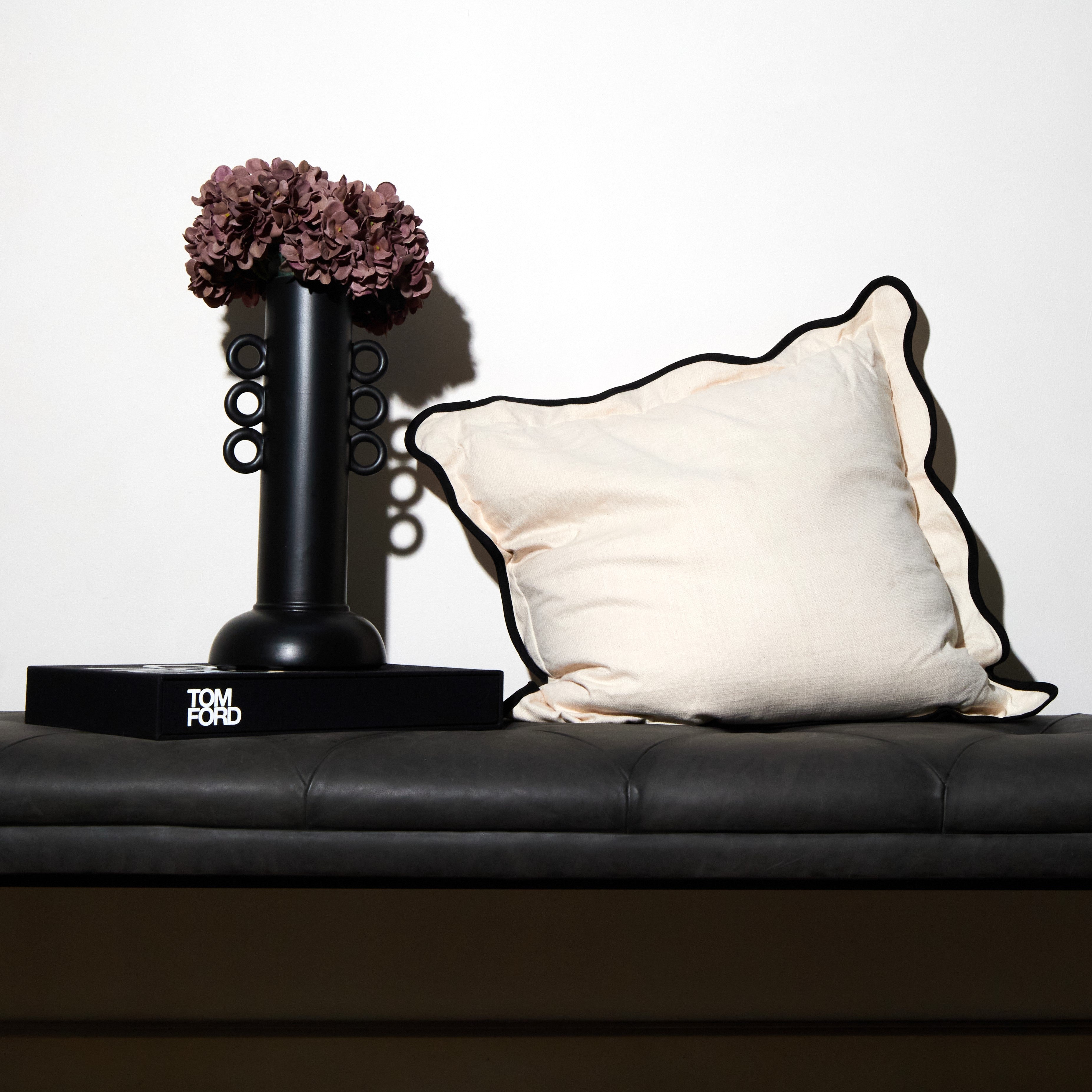 Rialheim Scatter with scallops and black edging with microfibre inner in a natural cotton fabrication and 60 by 60cm in size