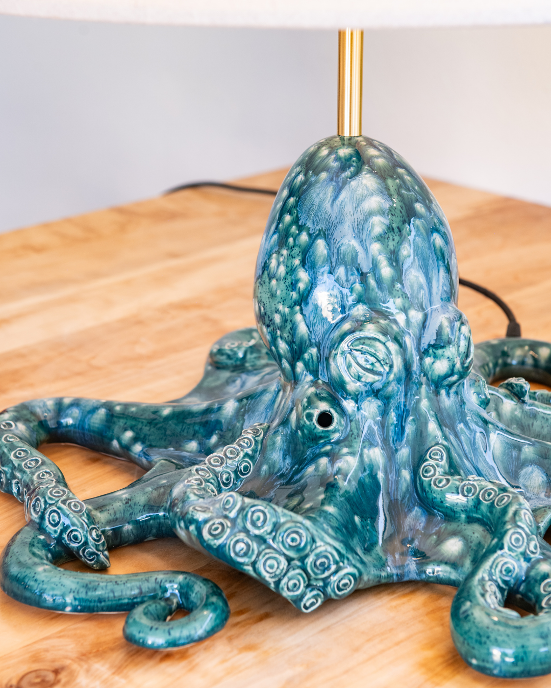 Blue octopus-shaped lamp on a wooden surface