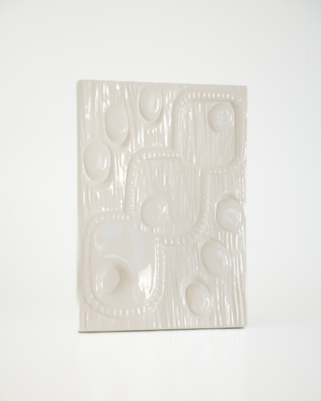 White ceramic tile with geometric pattern on a white background