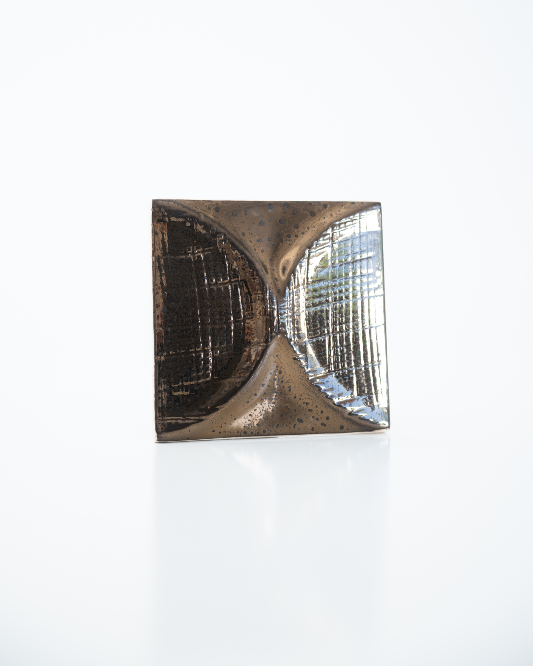 Decorative wall tile with geometric design on a white background