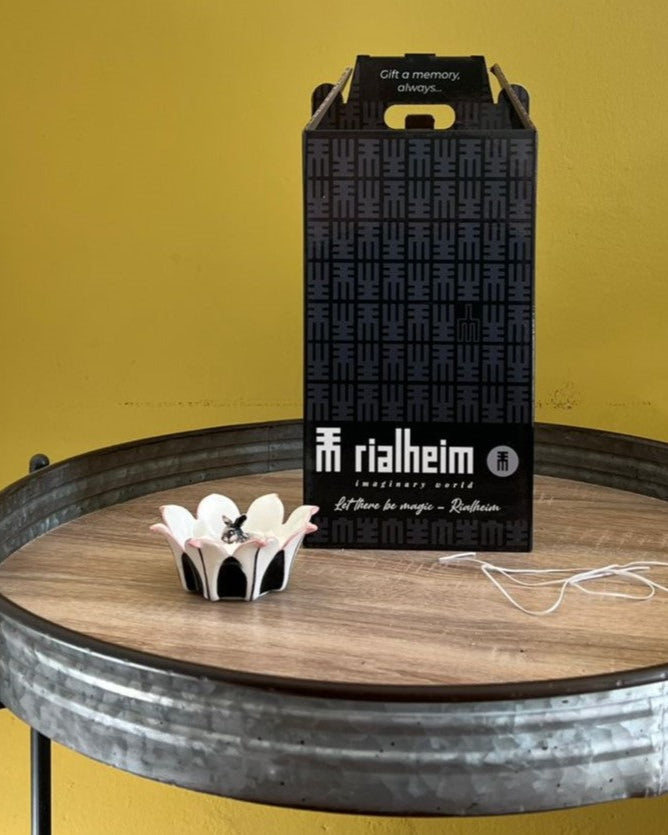 Black rialheim wine box on a wooden table with a yellow background