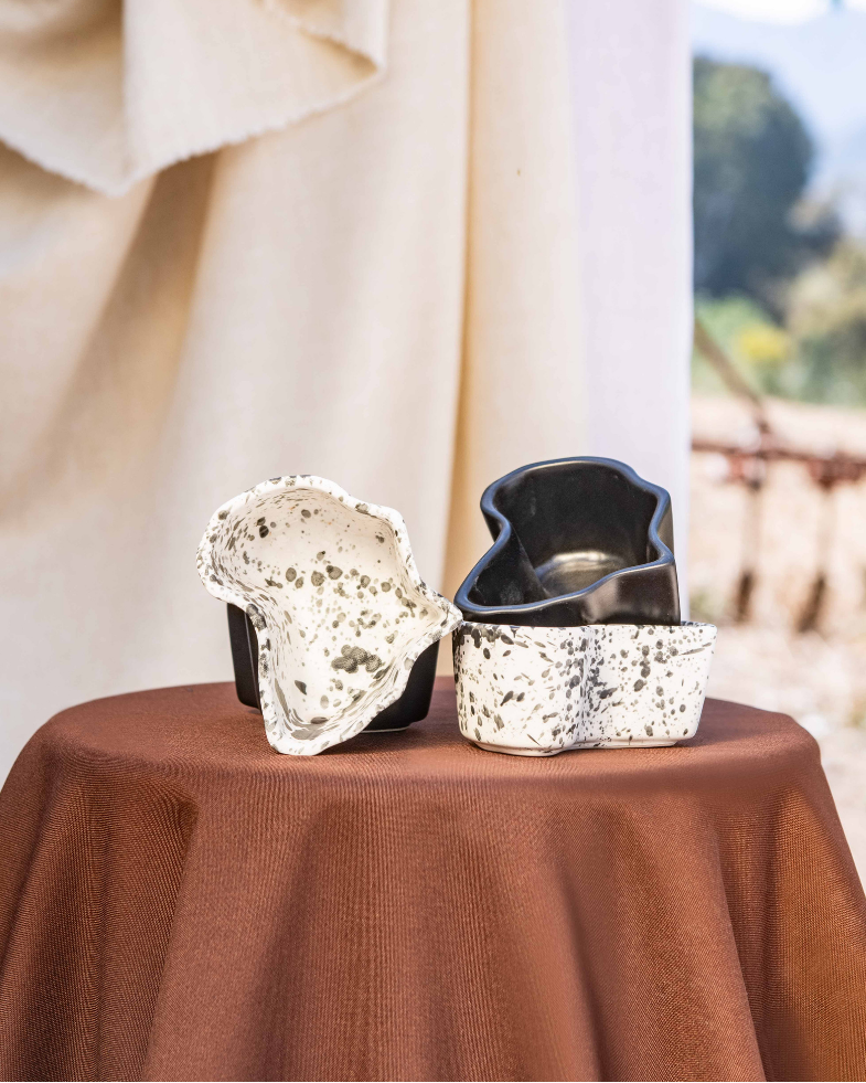Dessert display in africa shaped ceramic bowls on a table with a scenic background