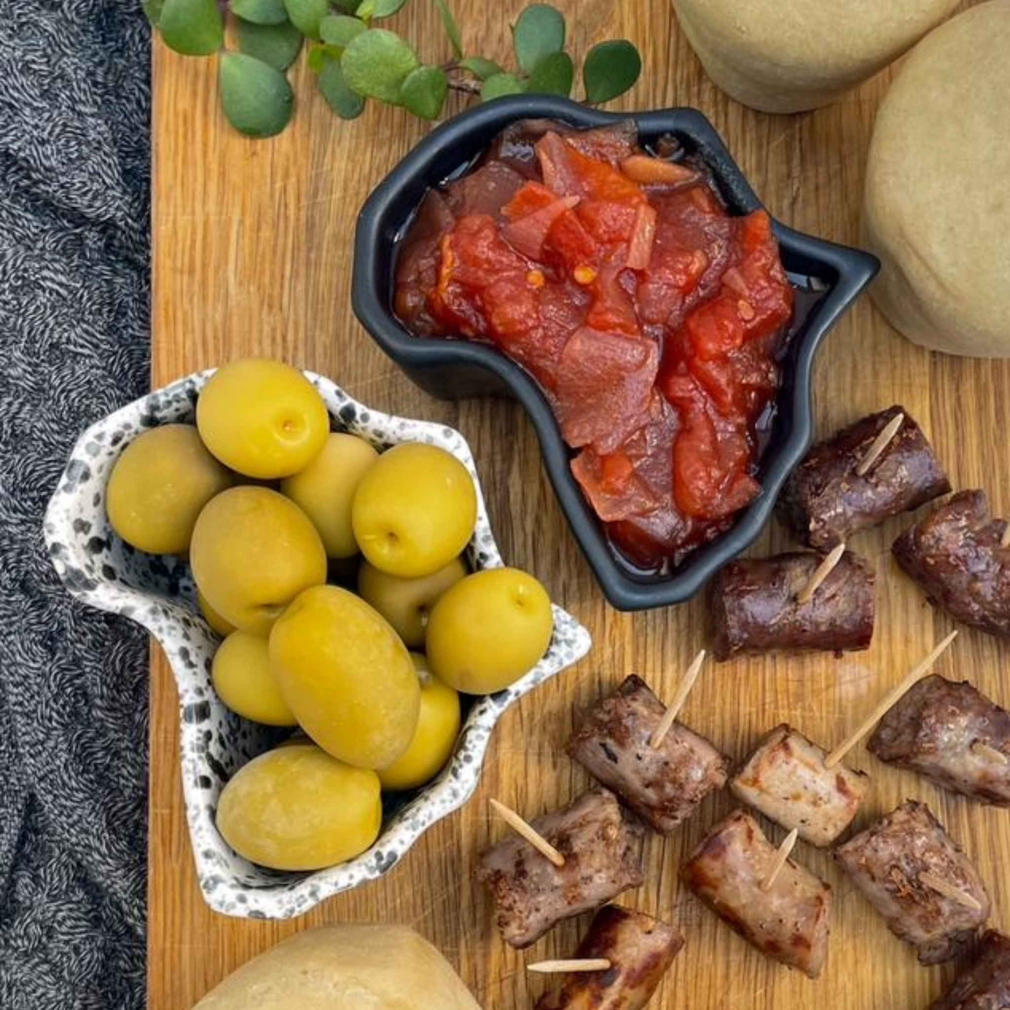 Dessert display in africa shaped ceramic bowls on a table with a scenic background