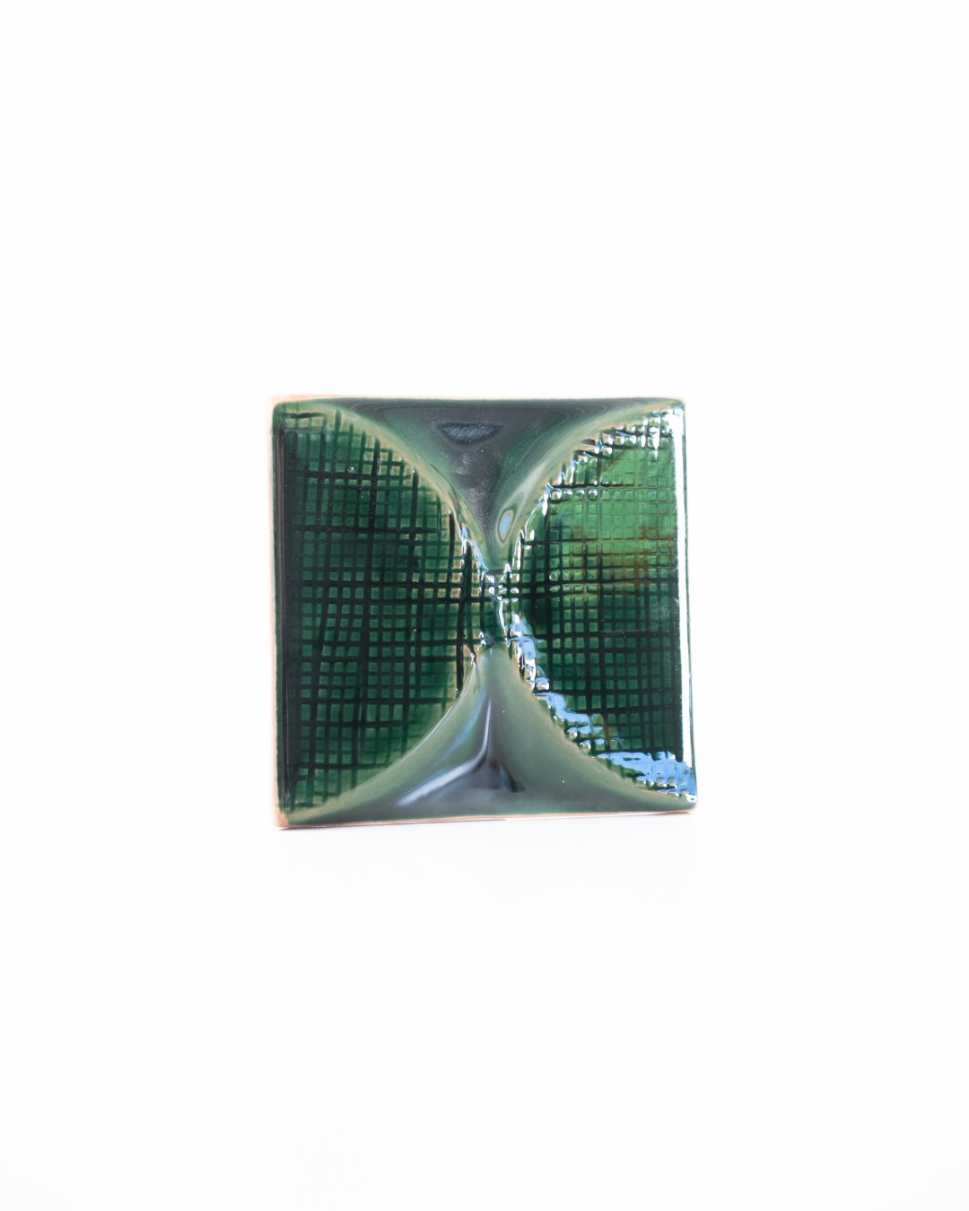 Green ceramic tile with grid pattern on a white background