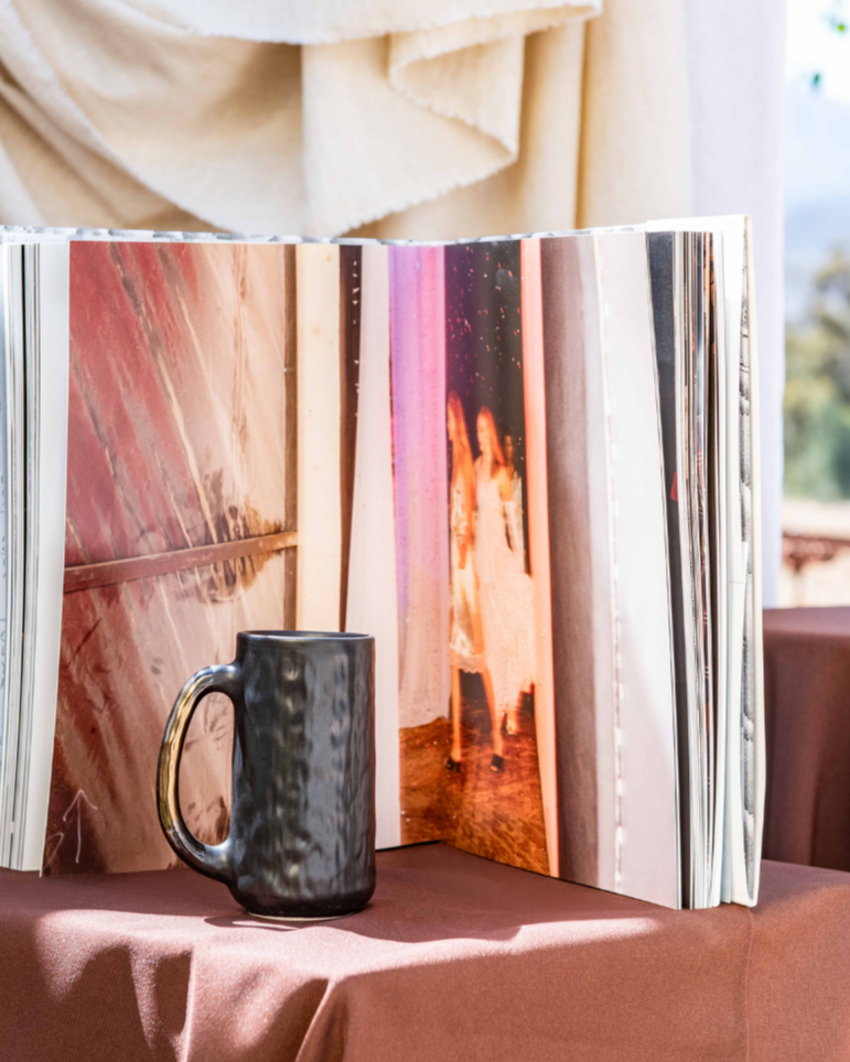 Handmade Mug in matt black on a posium with a scenic back ground