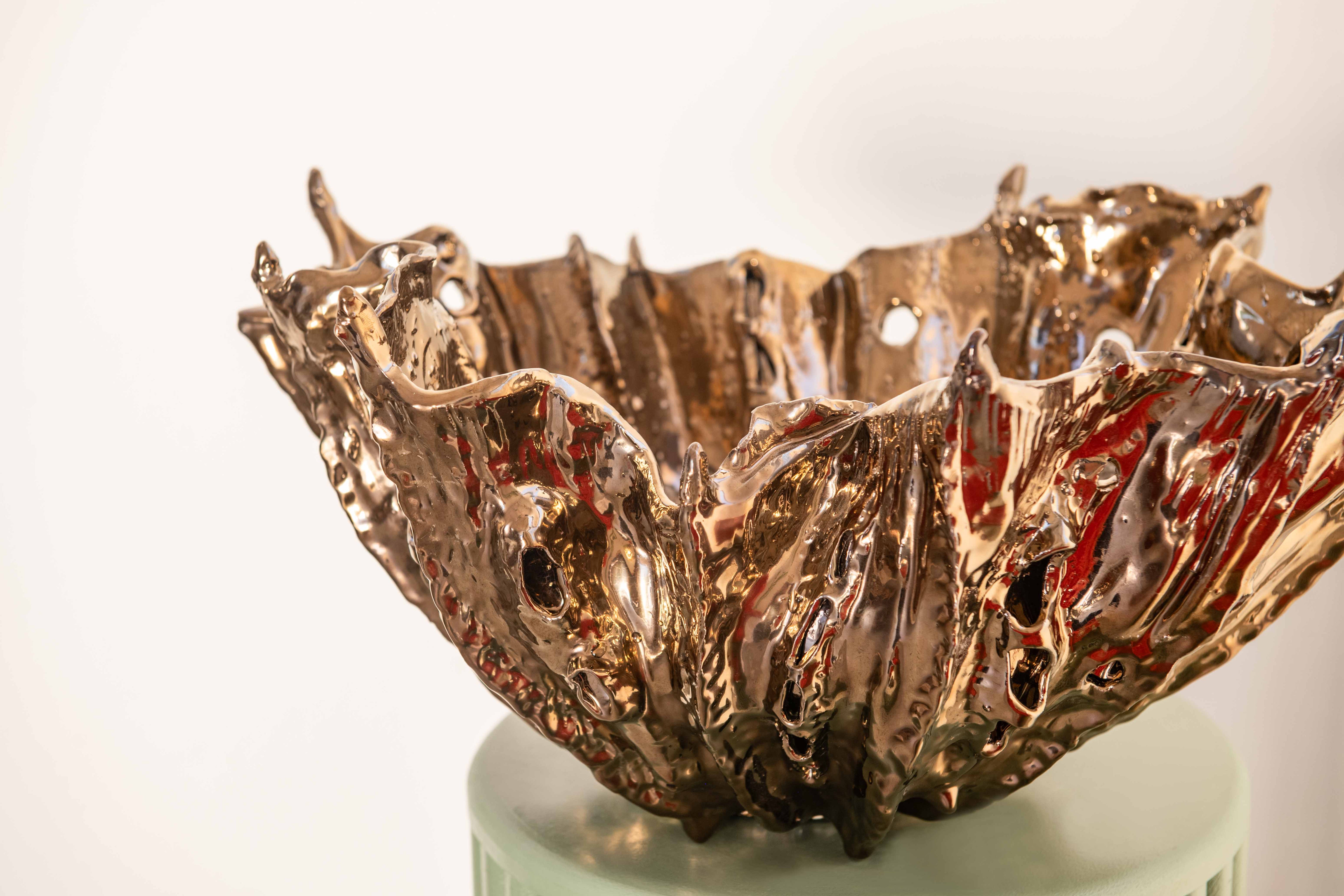 Bronze bowl with textured surface on a white background