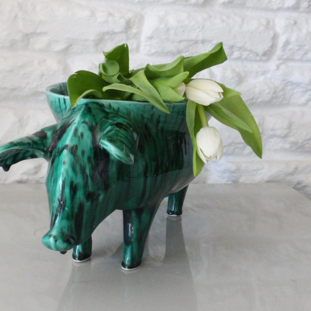 Rialheim Bowl n ceramics that is from a pig with a bowl on its back and it is emerald green