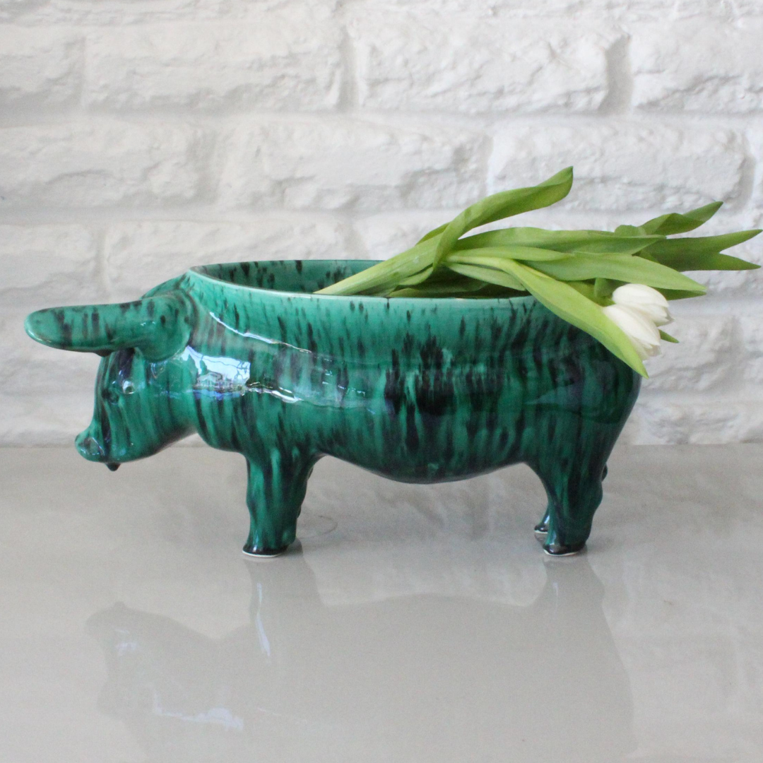 Rialheim Bowl n ceramics that is from a pig with a bowl on its back and it is emerald green