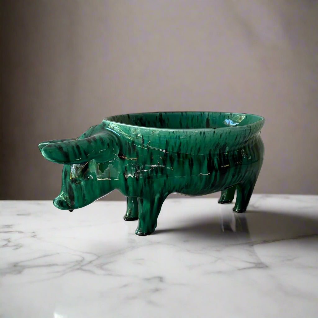 Rialheim Bowl n ceramics that is from a pig with a bowl on its back and it is emerald green