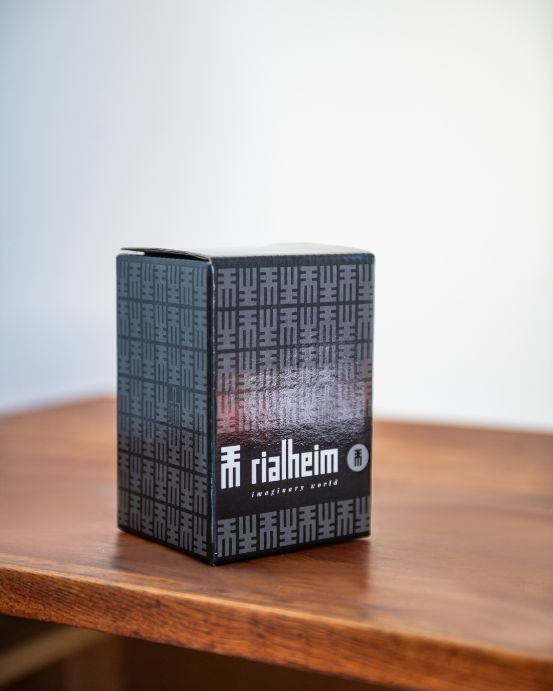 Black box with text on a wooden surface rialheim sandwax packaging