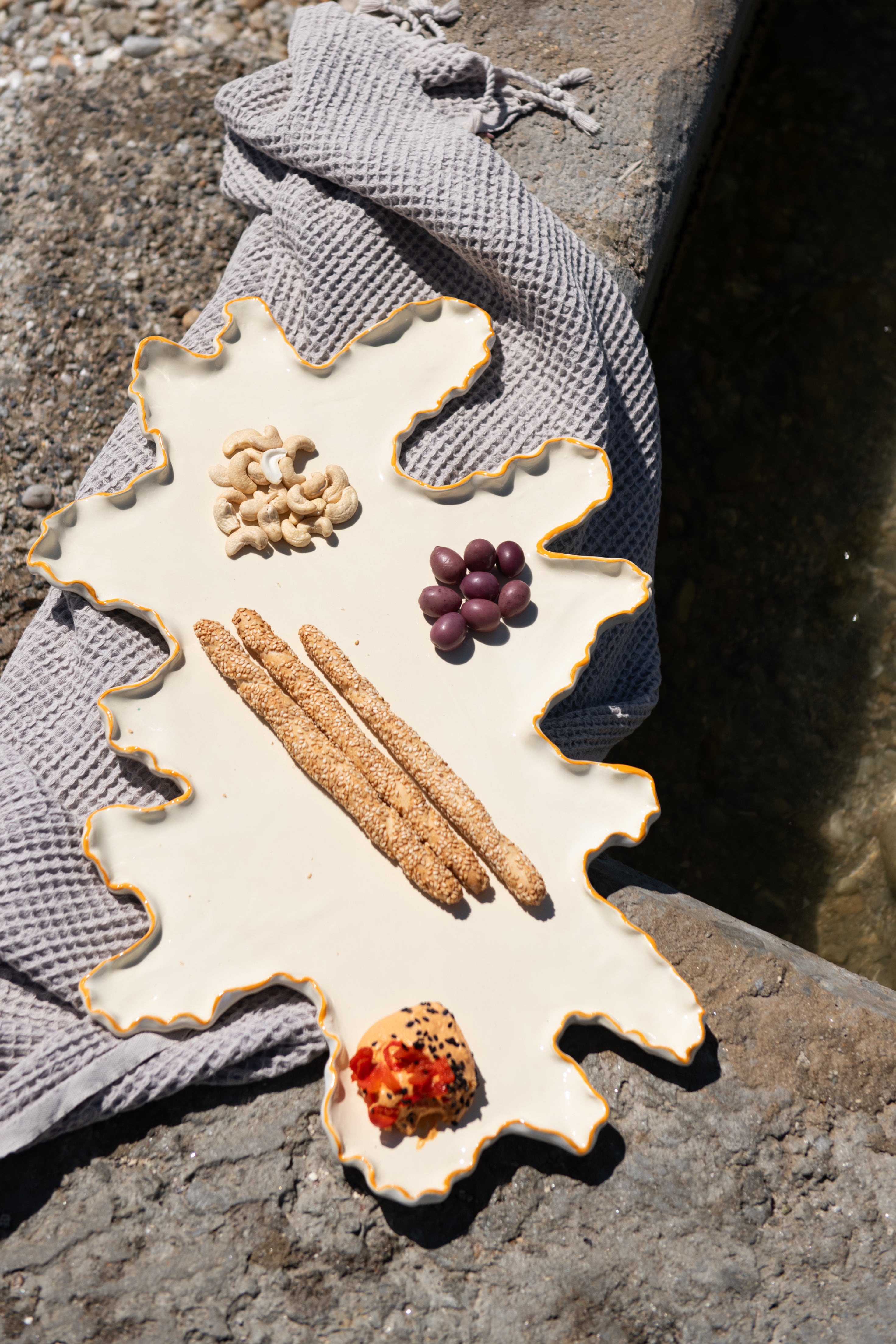 Decorative plate with food items on a stone surface