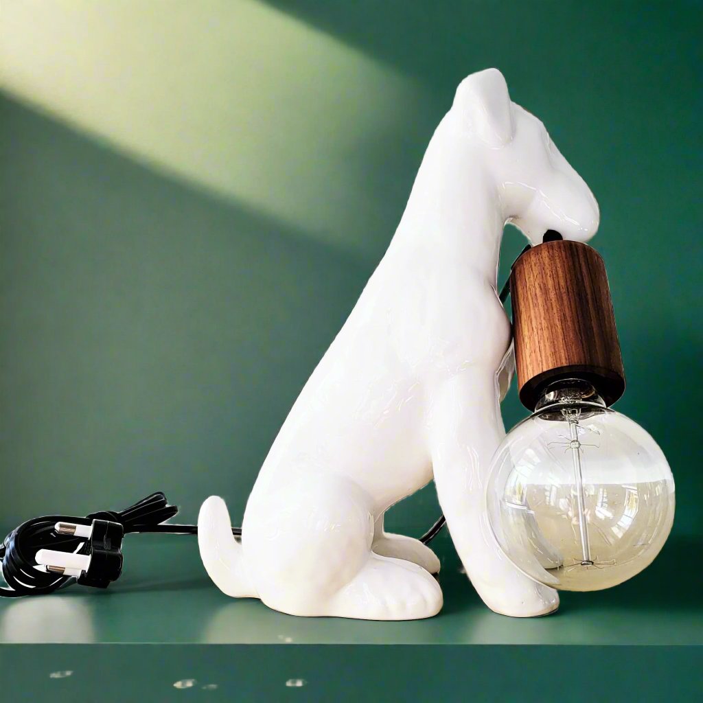 AIREDALE TABLE LAMP - Rialheim A table lamp shaped like an Airedale dog holding the bulb
