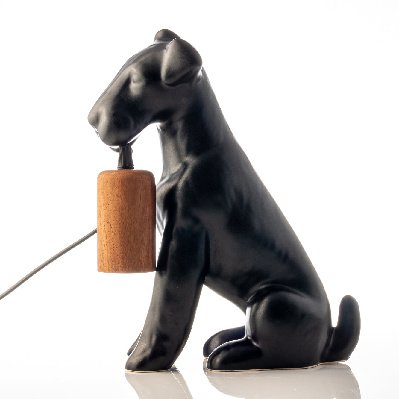 Airedale Table Lamp - Rialheim A table lamp shaped like an Airedale dog holding the bulb